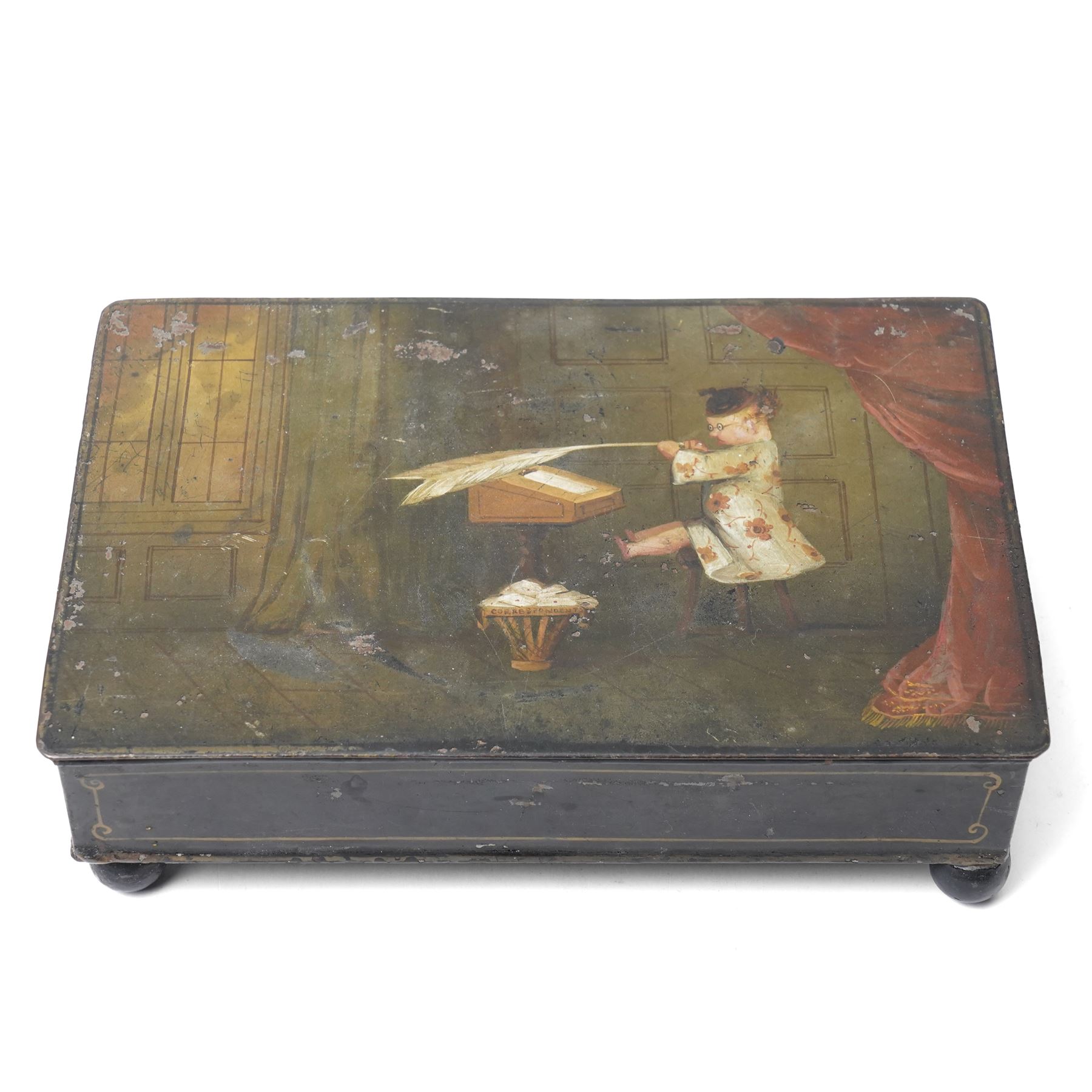 19th century toleware stationary or wafer box, possibly German, with painted cover depicting a child holding oversized quill, seated at a davenport, W20.5cm D13.5cm