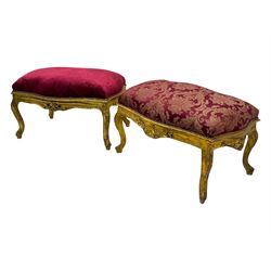 Pair of Louis XV-design giltwood stools, each upholstered in red damask fabric with slight variations in patterns, the carved frames adorned with scrolling foliage and shell motifs, raised on cabriole supports