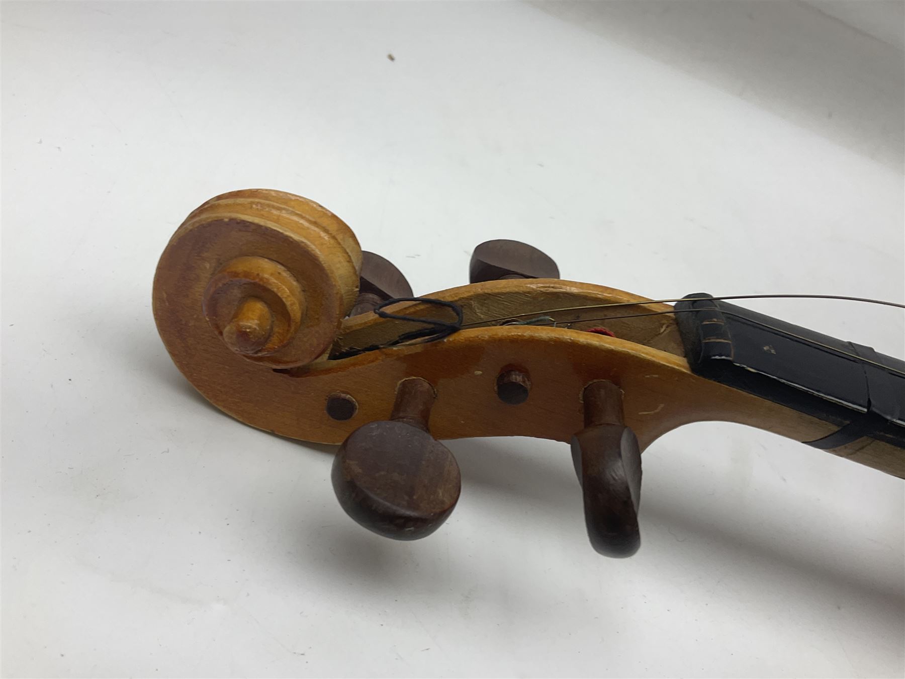 Four Chinese graduated violins - full size with 35.5cm two-piece back; three-quarter size with 33.5cm two-piece back; half size with 31cm two-piece back; and quarter size with 27.5cm two-piece back; all cased except full size; one with bow (4)