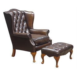  Georgian style wingback armchair and matching stool, upholstered in deeply buttoned brown leather, cabriole legs  