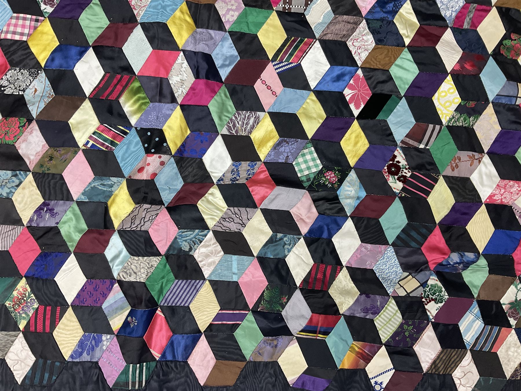 19th Century silk and satin tumbling blocks pattern patchwork quilt with black border 228cm X 196cm