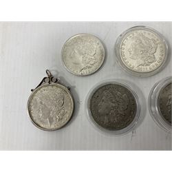 Six United States of America silver Morgan dollar coins dated 1881 O, 1881 S, 1882 O, 1882, 1898 mounted, 1900; with two replica 1880 O dollar coins
