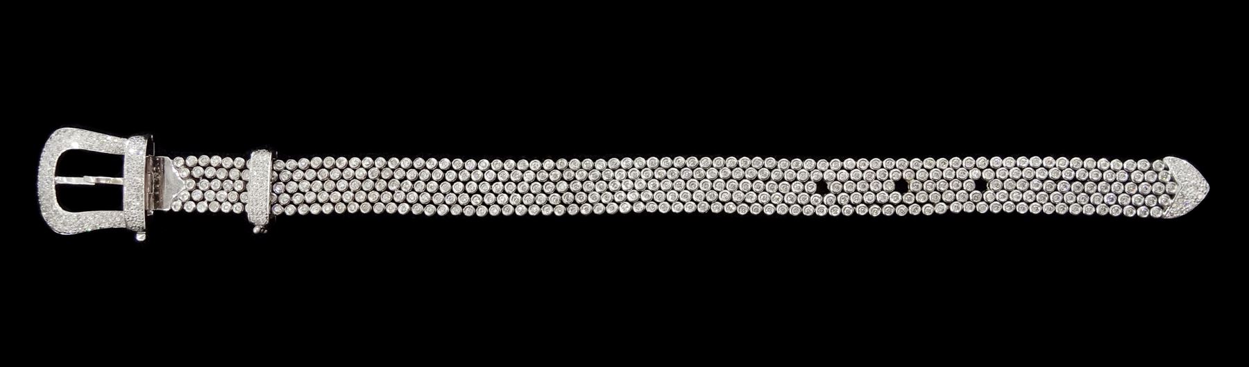 14ct white round brilliant cut diamond belt bracelet, the bracelet with rubover set diamonds, the buckle and clasp with pave set diamonds, stamped 14K, total diamond weight 5.35 carat