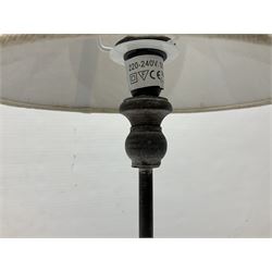 Table lamp, with a thin central stem upon a square stepped base, natural linen shade