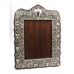  Edwardian silver on oak freestanding photograph frame by William Harrison Walter Birmingham 1902, with foliage, bamboo and flowerhead decoration, H34cm  