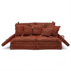 Large Knole design hardwood-framed three-seat drop-arm sofa, upholstered in crimson fabric decorated with trailing acanthus leaves and shields, together with scatter cushions 