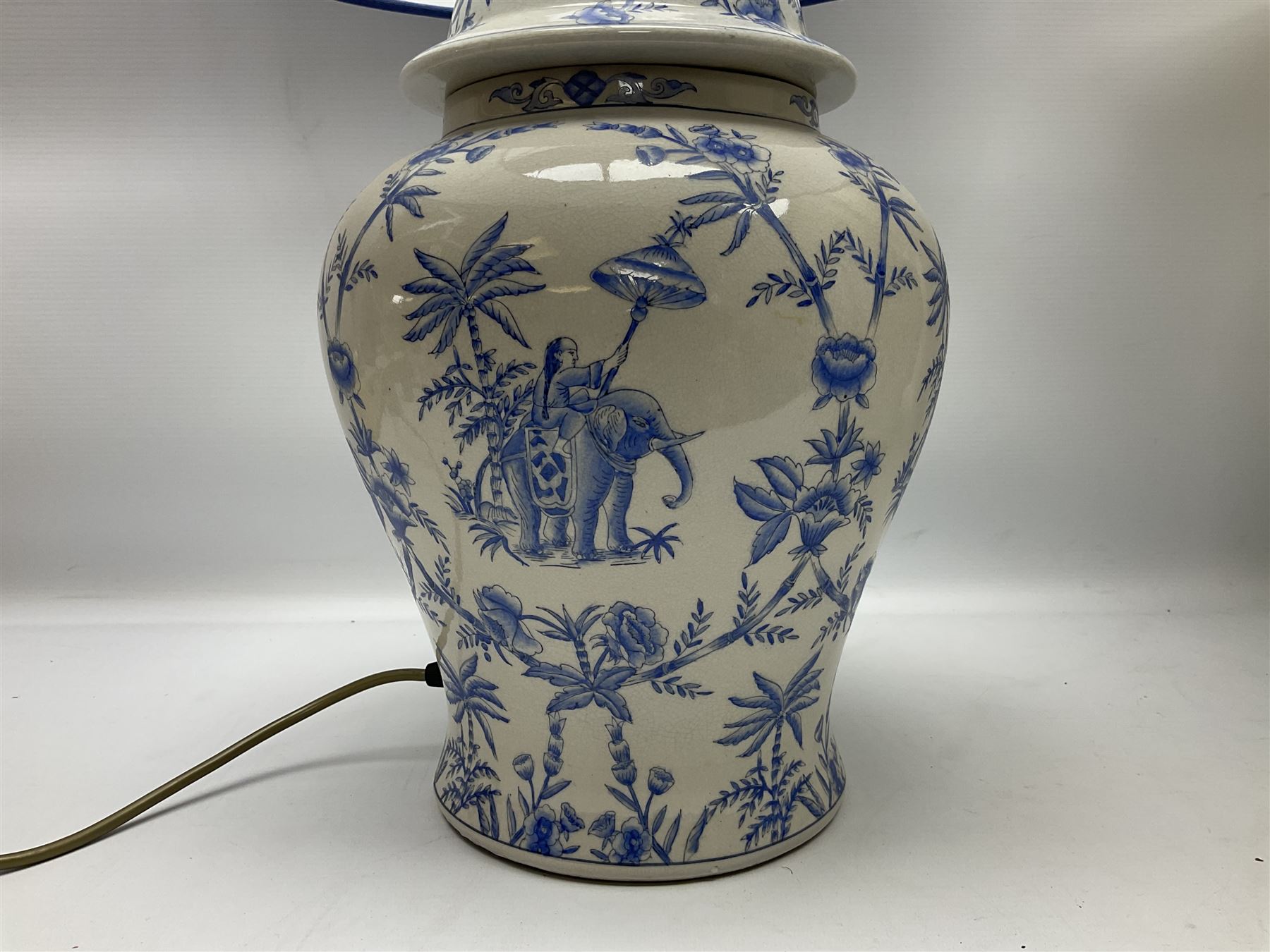 Modern pierced oriental white ceramic vase shaped table lamp, together with a blue and white baluster shaped example decorated with figures upon elephants, both with shades, tallest H83cm incl shade