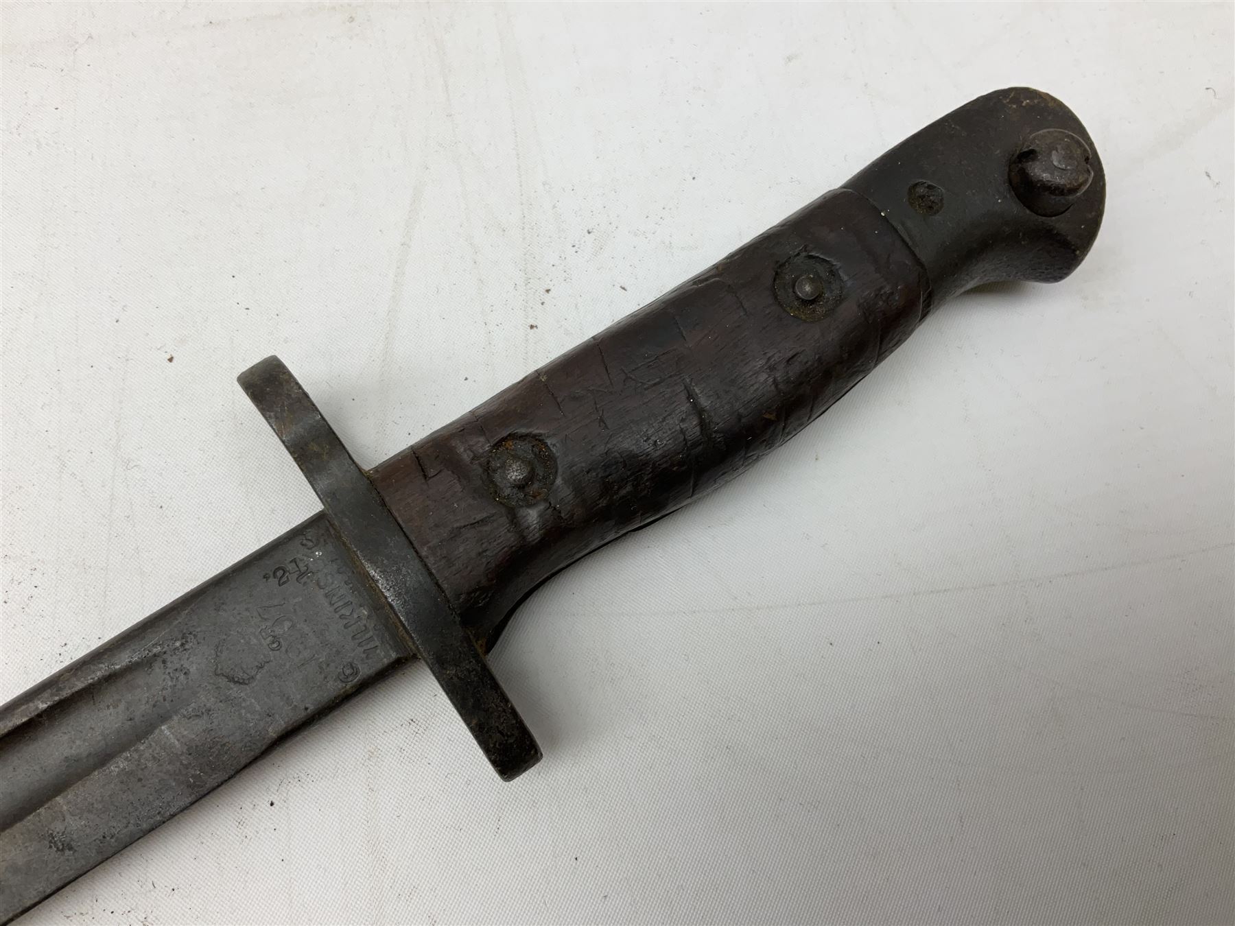 British Pattern 1907 bayonet with 43.5cm fullered steel blade; in leather scabbard with webbing frog L58cm overall; another Pattern 1907 bayonet lacking scabbard; and British Pattern 1888 Mk.I bayonet by Wilkinson London (no scabbard) (3)