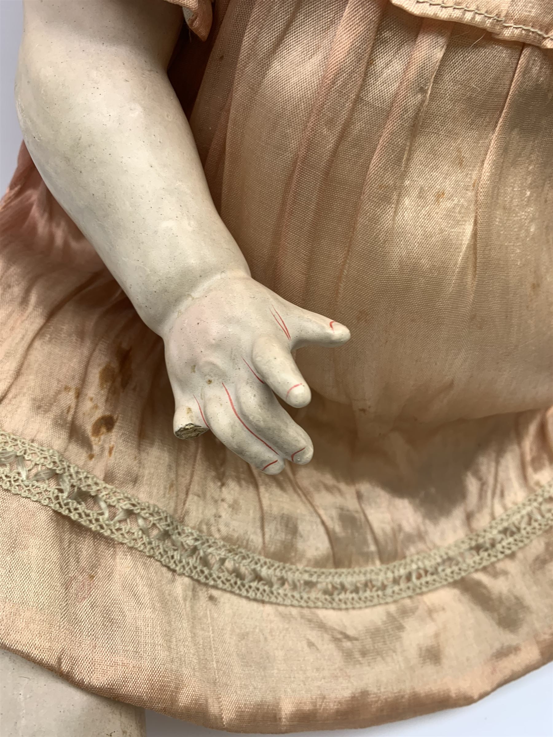 German bisque head doll with applied hair, sleeping eyes and open mouth with teeth and fixed tongue, on composition body with jointed limbs, marked 'P.M. 914 Germany 14' H65cm