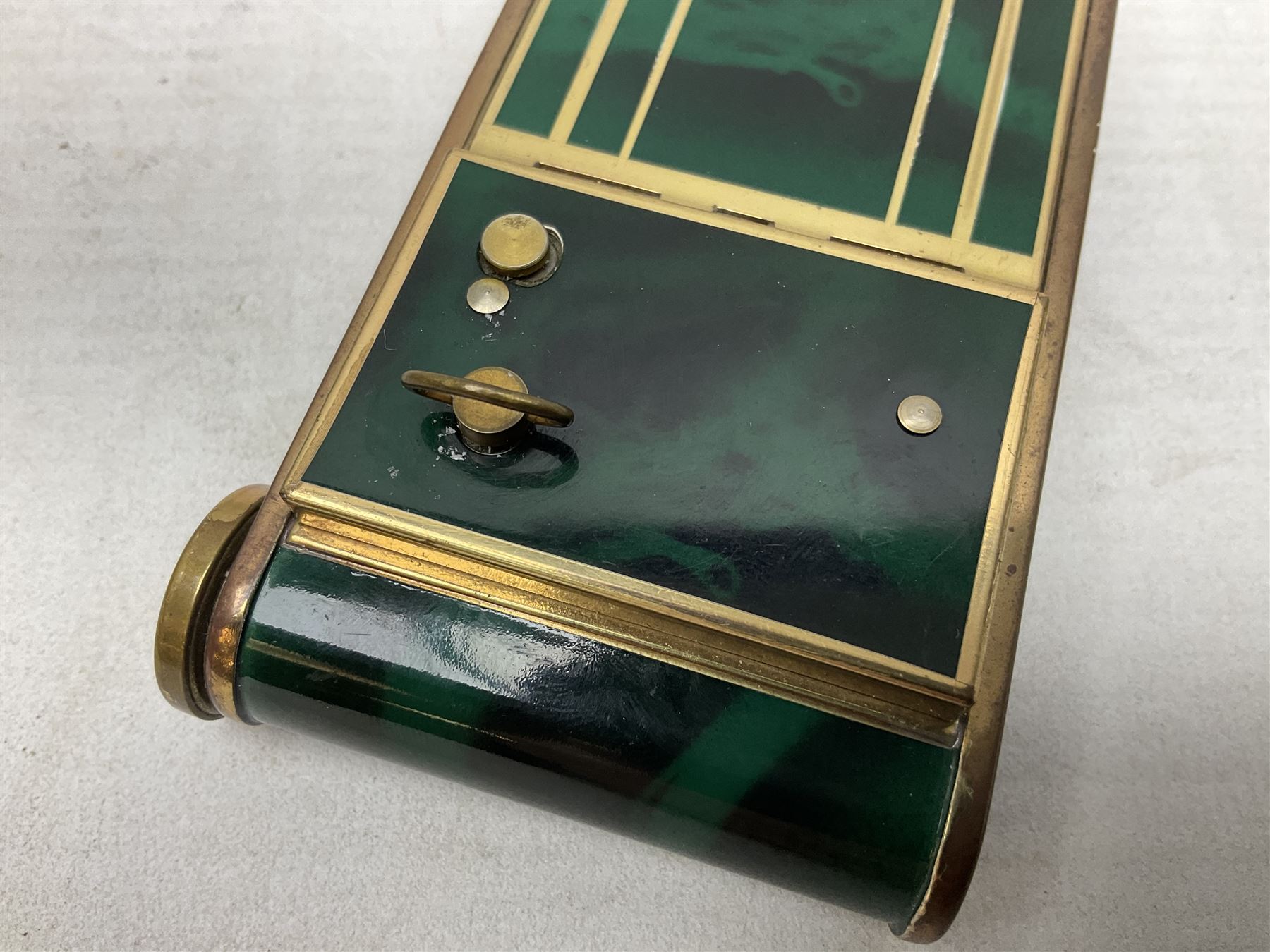 Art Deco camera shaped lady's musical compact and cigarette case, probably German, with green marble effect panels and gilt highlights, with large hinged opening to reveal engine turned brass interior with cigarette or lipstick holders, and the other side with musical mechanism and flip action powder compartment with mirror, L10cm