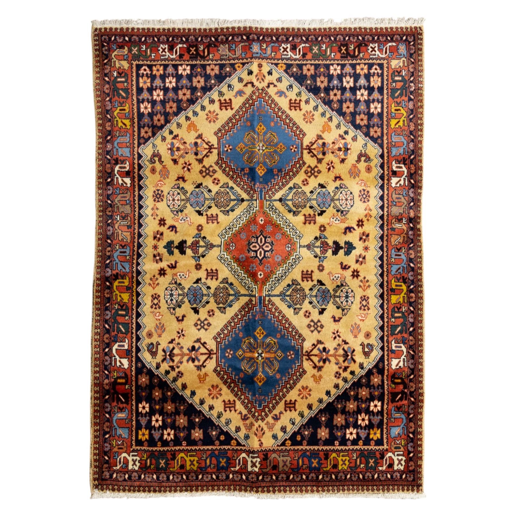 South Persian Yallameh hand-knotted rug, ivory ground, with a central stepped pole medallion design in blue and terracotta tones, surrounded by geometric tribal motifs incorporating stylised flowerheads, birds, hooked devices and angular vine work, enclosed by dark navy spandrels and a terracotta border with repeating geometric motifs, flanked by narrow patterned guard stripes, with cotton fringes