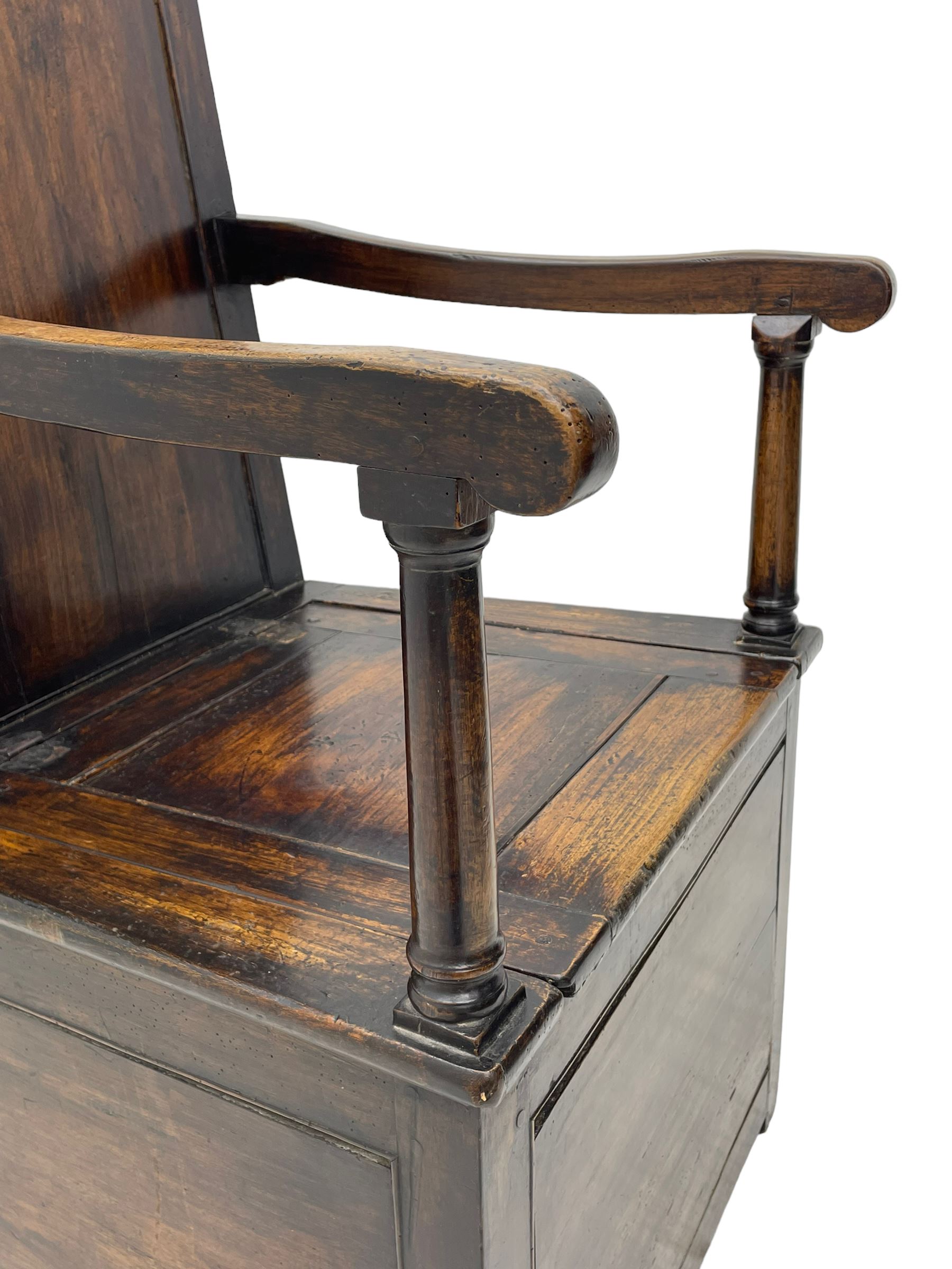 18th century elm box-seat lambing chair, dished cresting rail over panelled back, panelled hinged lid flanked by two turned arm supports