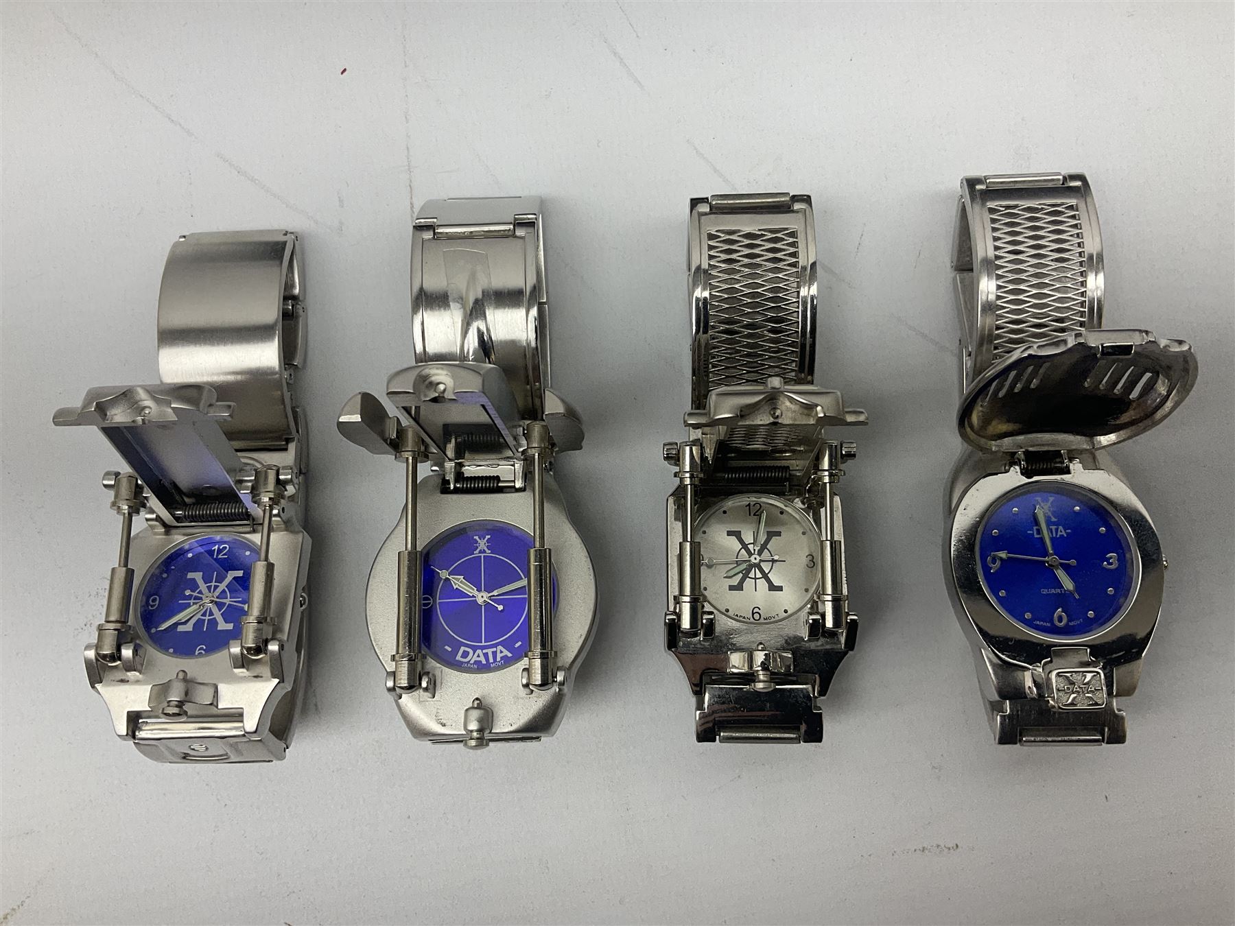 Four X Data stainless steel wristwatches, two Marc Gay wristwatches and one other, all with cover plates