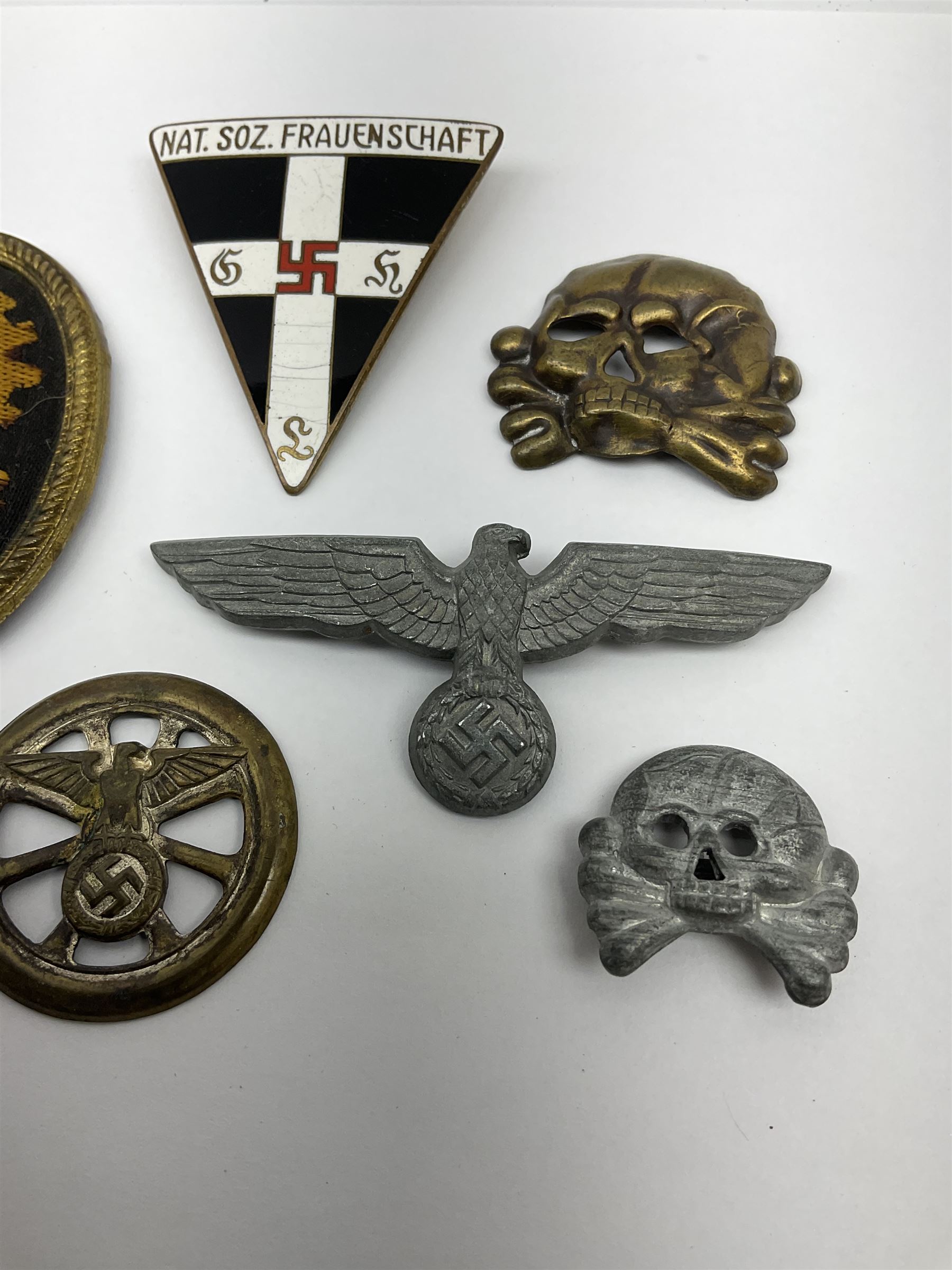 Six WW2 German badges - cap badge D.A.F. labour front; SS skull cap insignia First pattern 1925-35; Frauenschen Mother's Union; tank driver collar badge 1939-42; N.S.K.K. cycle corps; and officer's cap insignia 1940-42 (6)