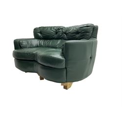 Two seat serpentine sofa, upholstered in green buttoned leather