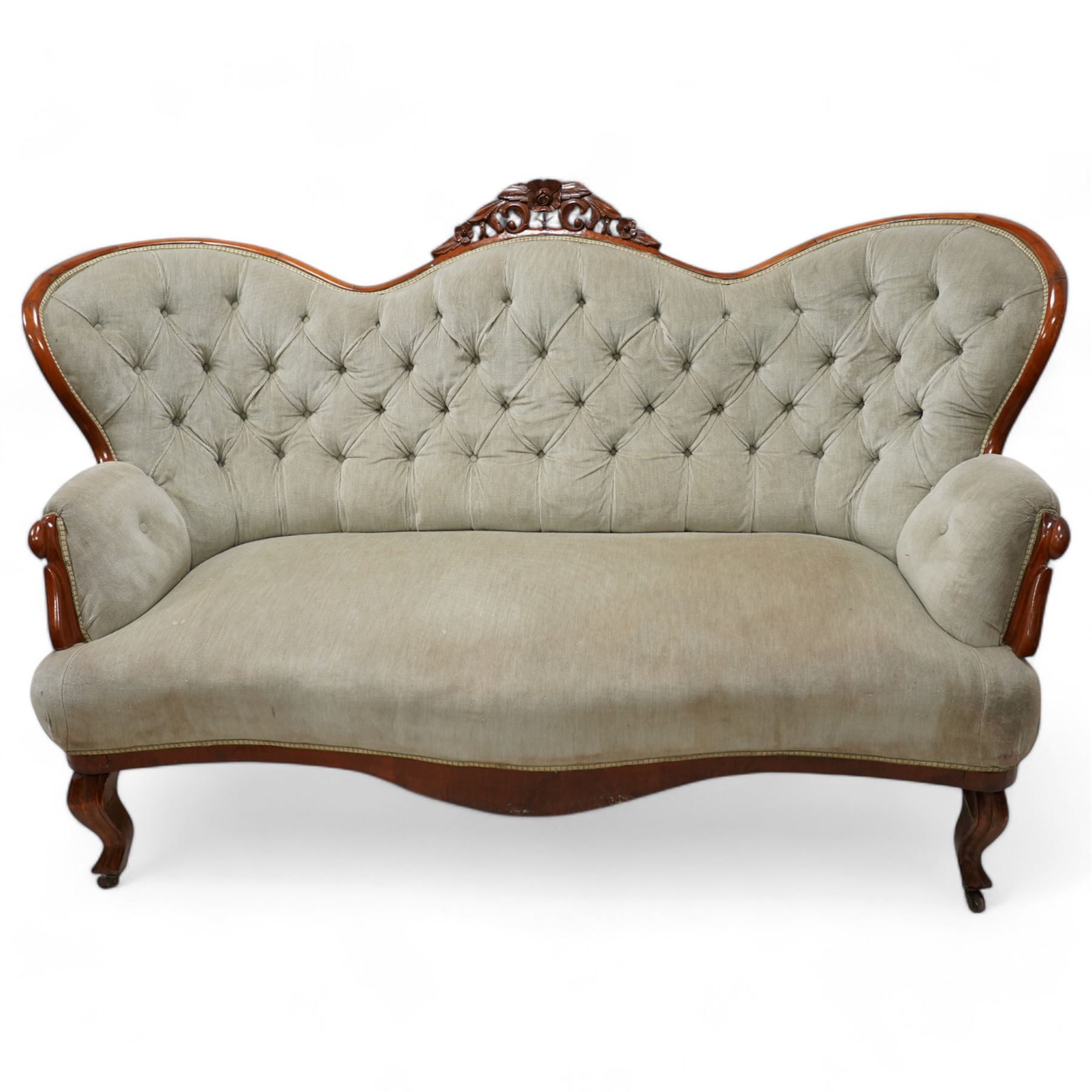 Victorian walnut double-ended settee, shaped cresting rail with foliate carved pediment, upholstered in buttoned sage green fabric, on cabriole feet