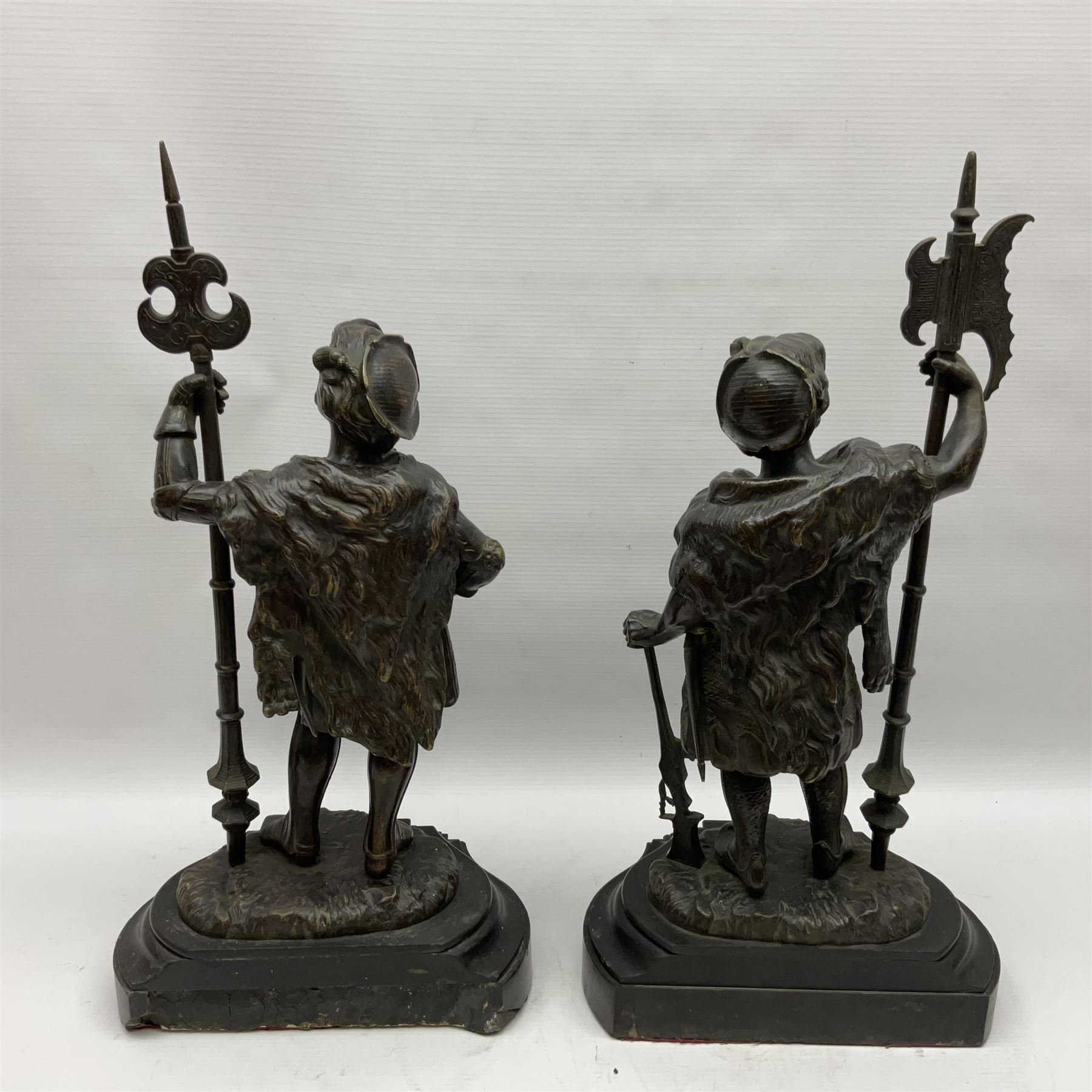 Pair of bronzed figure modelled as a hunter in traditional dress, each holding a pike, H48cm