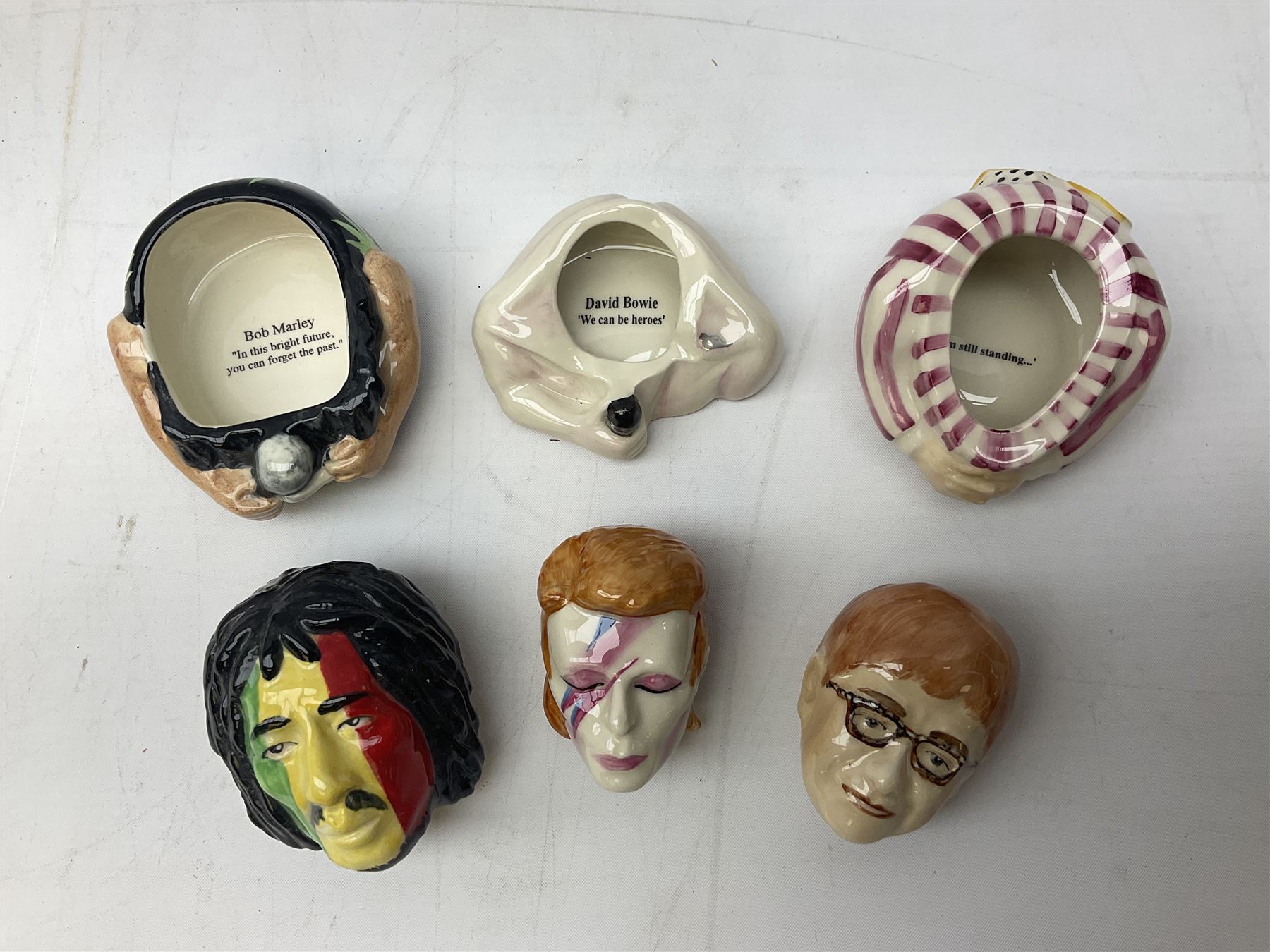 Fifteen Face Pots by Kevin Frances, all of music interest, to include the Beatles; Paul 'Kookoocachu', 'Love Is All You Need', 'Octopus's garden', 'While My Guitar Gently Weeps', 'All You Need Is Love' and 'Everybody's talking and no one says a word', Elton John; I'm still standing, Buddy Holly; 'That will be the day', David Bowie 'We can be heroes' , Mick Jagger prototype colour type etc, all boxed  