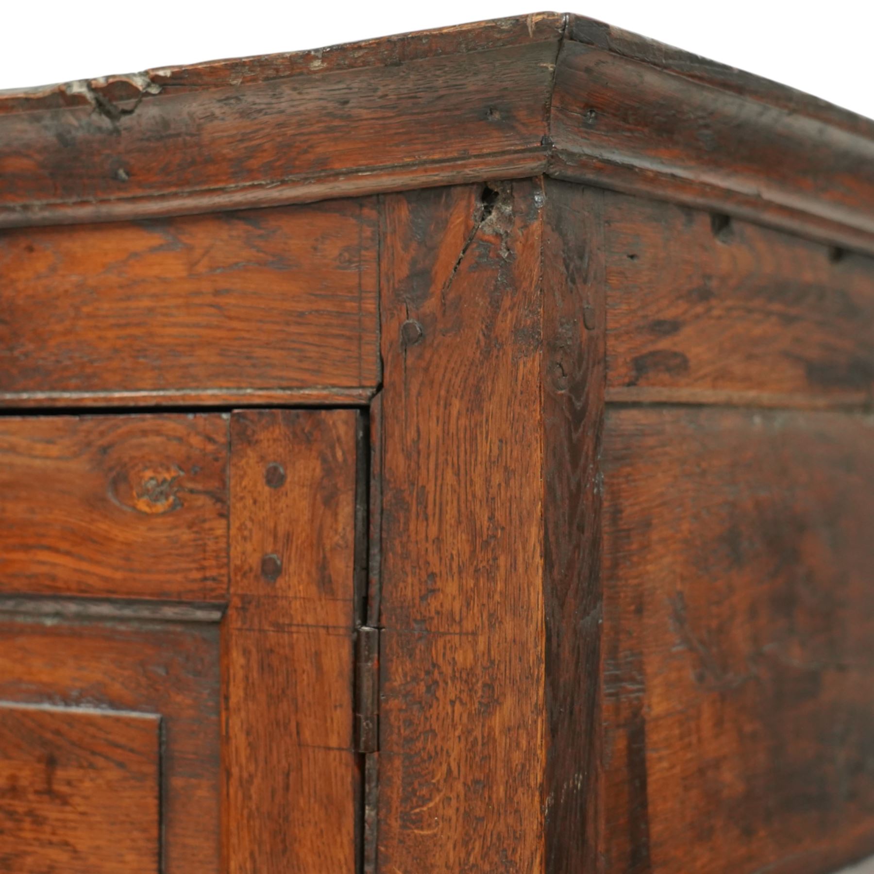 Georgian rustic oak housekeeper’s cupboard, moulded cornice above a pair of fielded panel cupboard doors enclosing a boarded interior with central divider and hanging hooks, the base fitted with two long drawers with brass swan neck handles, raised on stile supports