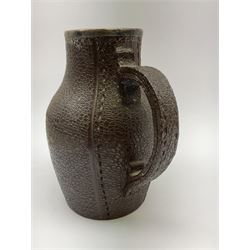 A Doulton Lambeth stoneware jug, with silver mounted collar, hallmarks rubbed, maker's mark probably Cornelius Desormeaux Saunders & James Francis Hollings (Frank) Shepherd, the leather effect body titled 'Drinke Faire Don't Sware', with impressed marks beneath including 'Manufactured for Sidney W Allen 39 White Rock Hastings', H18.5cm. 