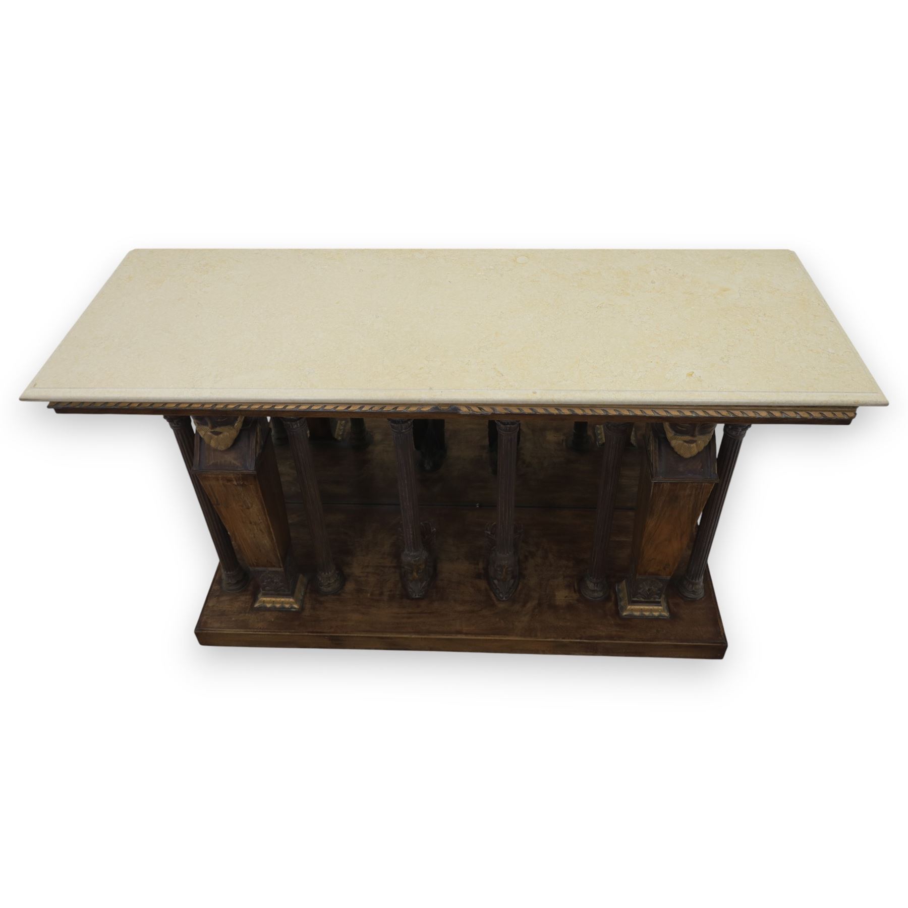 20th century carved hardwood console table in Renaissance taste, moulded marble slab top over a frieze decorated with festoons and roundels, the angles carved with grotesque mask brackets, supported by six fluted columns with carved mask and paw feet terminals, on a stepped plinth base with mirrored back