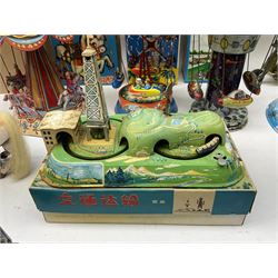 Mid 20th century and later tin plate clockwork toys, to include merry-go-rounds, spaceship carousel, walking robot, Schylling airport control tower, monkey riding horse, astronaut space station etc, including German and Japanese examples, some with boxes (12)