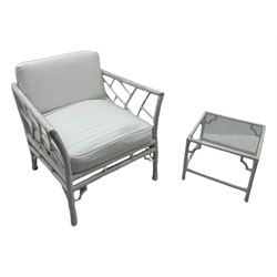 Late 20th century faux bamboo conservatory sofa, white painted frame with geometric openwork back and sides, loose cream cushions, on cylindrical supports (W134cm, D76cm, H80cm); matching armchair (W75cm, D76cm, H80cm); matching coffee table with glass insert (W46cm, D45cm, H36cm)