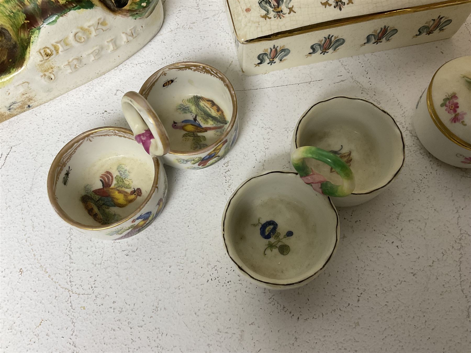 Staffordshire figure of the Duke of Wellington on a bay horse, H30cm in red uniform, together with a similar Staffordshire figure of Dick Turpin, pair of Staffordshire style dogs, H27cm, three Meissen style double salts and two trinket boxes 