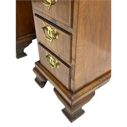 Early 18th century Queen Anne figured walnut kneehole desk with secretaire drawer, moulded and book matched top with walnut band, the top drawer with fall front enclosing small drawers and pigeon holes, fitted with nine drawers and central recessed cupboard, on ogee bracket feet