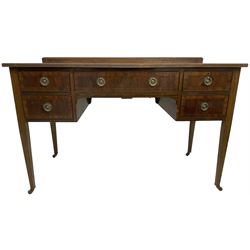 Edwardian mahogany kneehole dressing table or desk, reed moulded rectangular top over five drawers, on square tapering supports with brass castors 