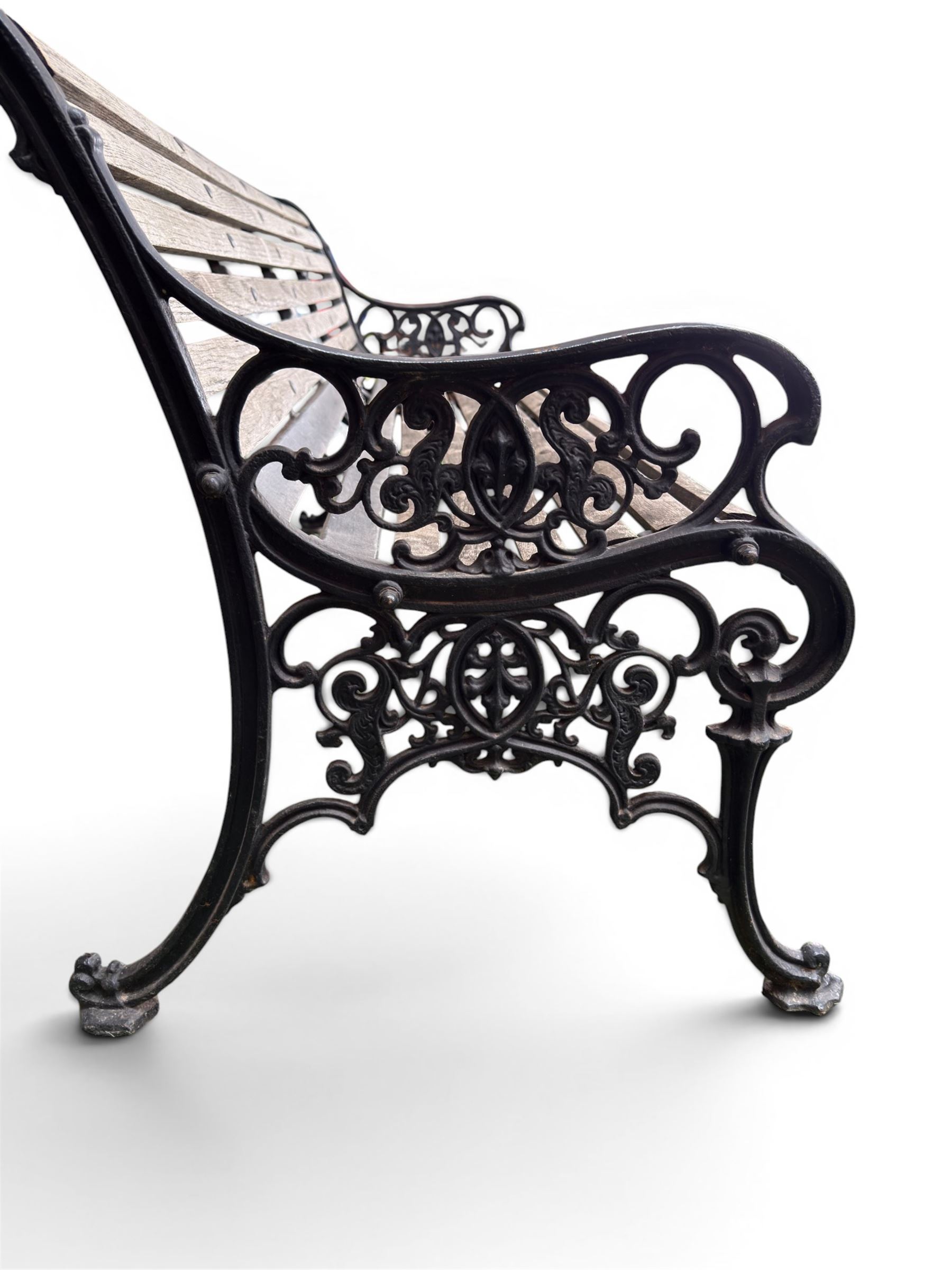 Victorian Andrew McLaren pattern cast iron bench, the ornate ends with detailed scrollwork, joined together with a cast iron seat and backrest frame supporting gently weathered oak slats, Victorian diamond stamp mark