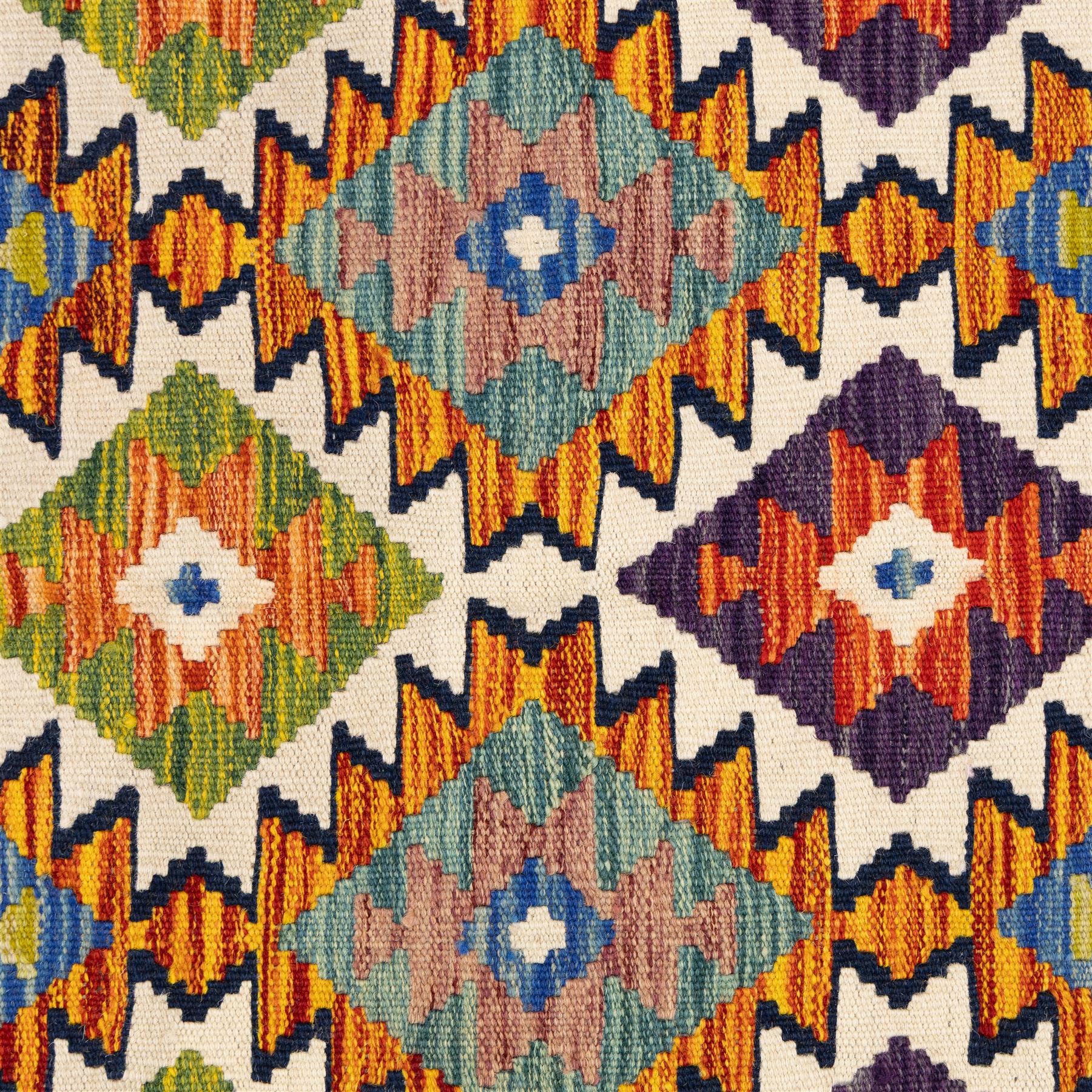 Two Chobi flatweave kilims with a repeating stepped diamond medallion design in live green, rust, teal, purple, and ivory, framed by chevron and geometric borders, 121x80cm & 87x60cm 