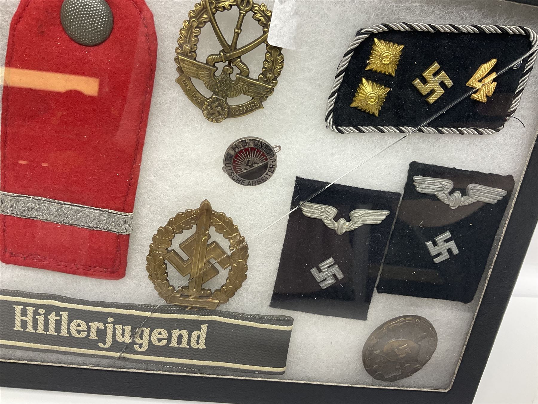 WW2 German Don Cossack epaulettes; and quantity of German insignia including SA Sports Badge for war wounded, Hitler Youth badge, Young Cossacks badge, Wound badge, Hitler Youth cuff title etc; in glass topped display box.