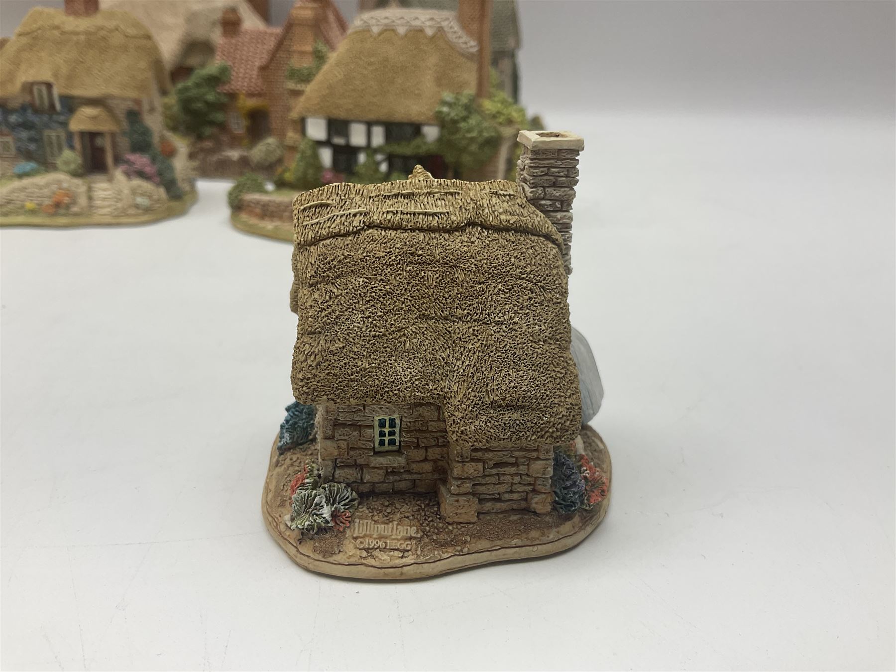 Ten Lilliput Lanes, comprising from Midlands Region Witham Delph, Jun and Disorderly, From South West Region Puffin Row, Moonlight Cove, The Cuddy, and from South West Region, The Rustlings, Saxton Cottage (1988), Marigold Meadow, Calendar Cottage and Little Lupins, all with boxes and deeds 