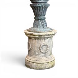 Large impressive Classical cast bronze center-piece urn, twin scroll handles with grape garlands, cherub masks and relief detail, raised on a circular cast stone pedestal with moulded detail