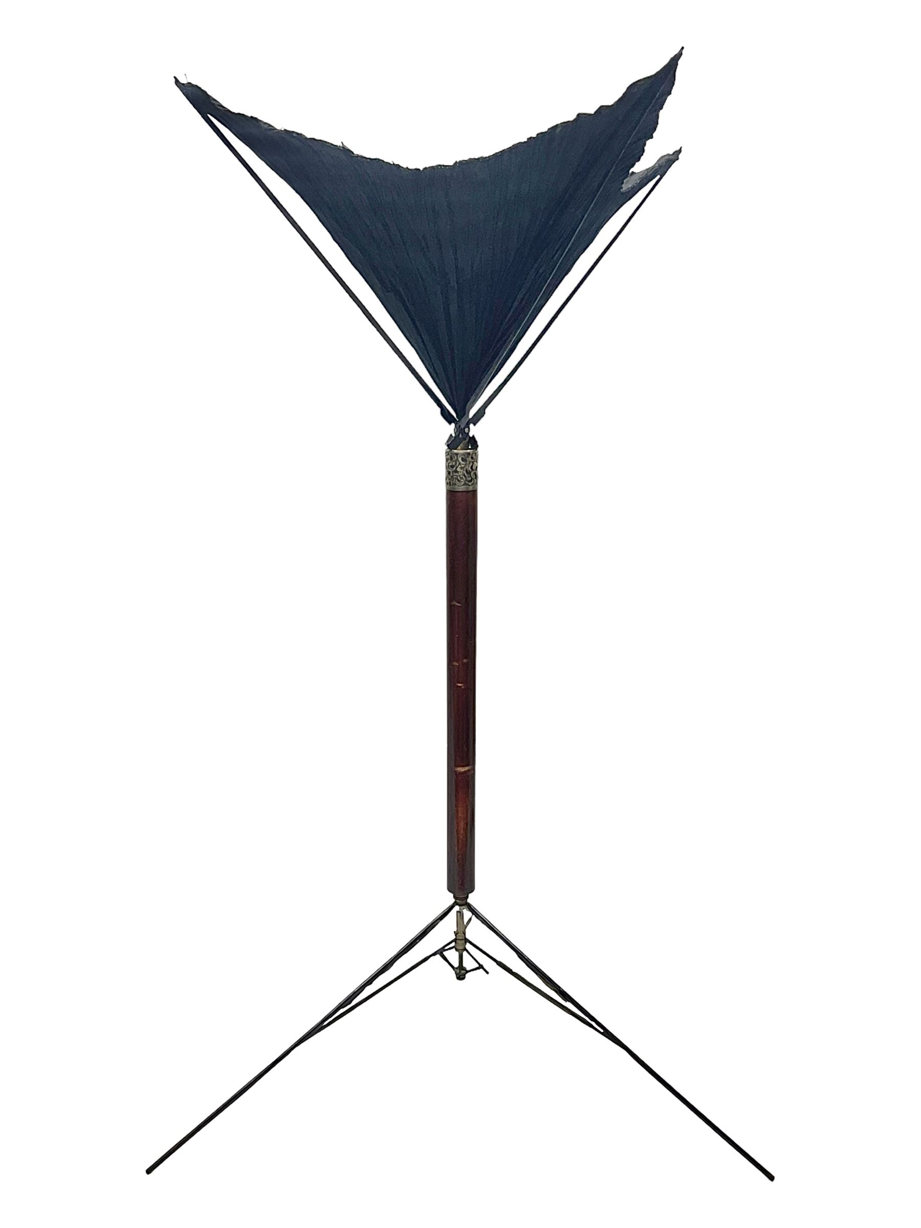 Victorian magician's cane, the mahogany walking stick twisting apart to reveal an internal mechanism, opening to tripod and black silk fold out magician's table, with horn handle and silver mount, hallmarked Birmingham 1891