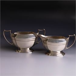 Art Deco three-piece silver tea service, comprising teapot with removable tea strainer, open sucrier and milk jug, all of hexagonal form, the teapot with wooden handle and finial, all hallmarked James Deakin & Sons, Sheffield 1925, together with a matched pair of silver sugar tongs, hallmarked