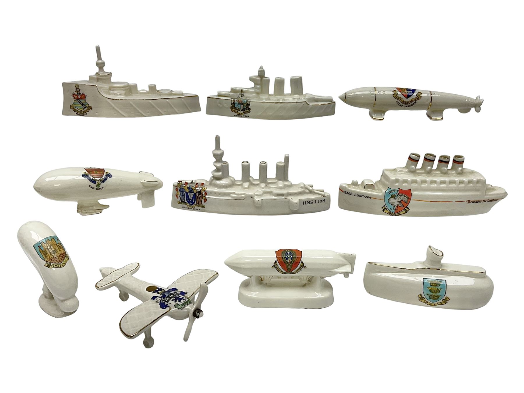 Ten WW1 crested china military models comprising submarine, four ships including Lusitania, four Zeppelins/balloons and an aircraft; various makers including Arcadian China, Swan China, Carlton China, Waterfall, Grafton China etc; various crests including Saint Neots, Great Yarmouth, Tewksbury, Swanage, Simons Town, Hull etc (10)