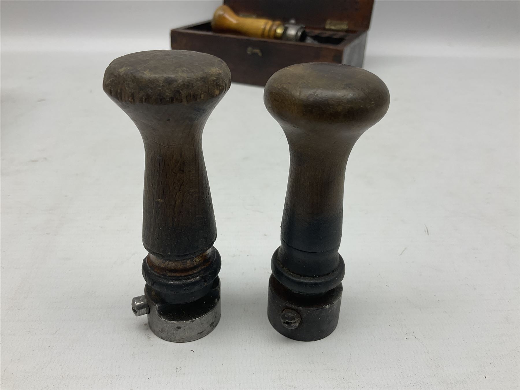 Two Post Office hand stamps 'Heversham Milnthorpe Cumbria' and 'Cimla Neath', together with two hand stamp bodies and various date numbers, housed in a fitted box