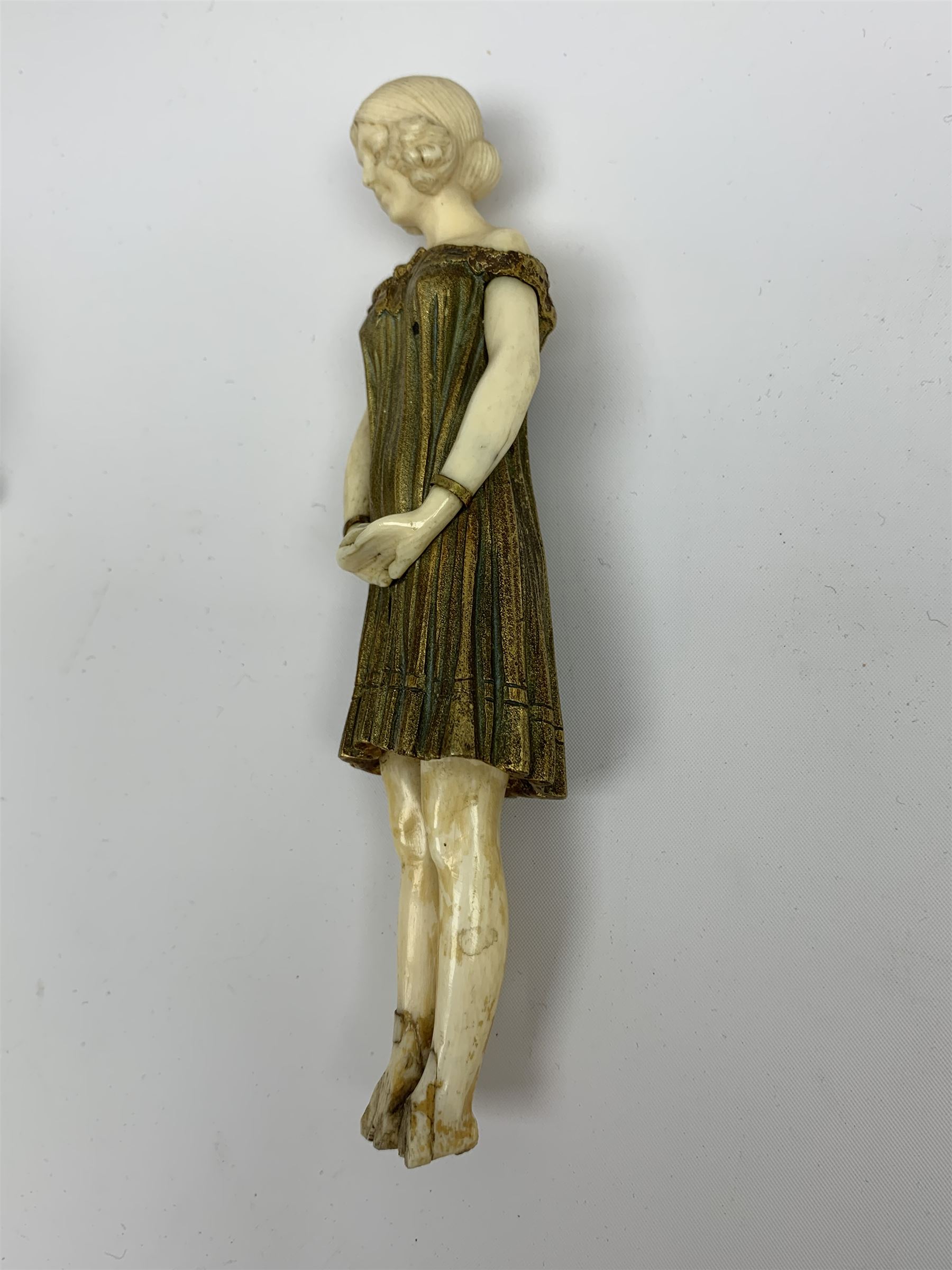 Demetre Chiparus (1886-1947): Innocence, a gilt bronze and ivory figure, circa 1925, standing in contemplative post with hands clasped, upon onyx plinth, signed to base, H24.4cm