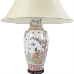 Chinese famille rose table lamp, of baluster form, decorated with birds in blossoming branches, upon a circular wooden base with shade, H78cm