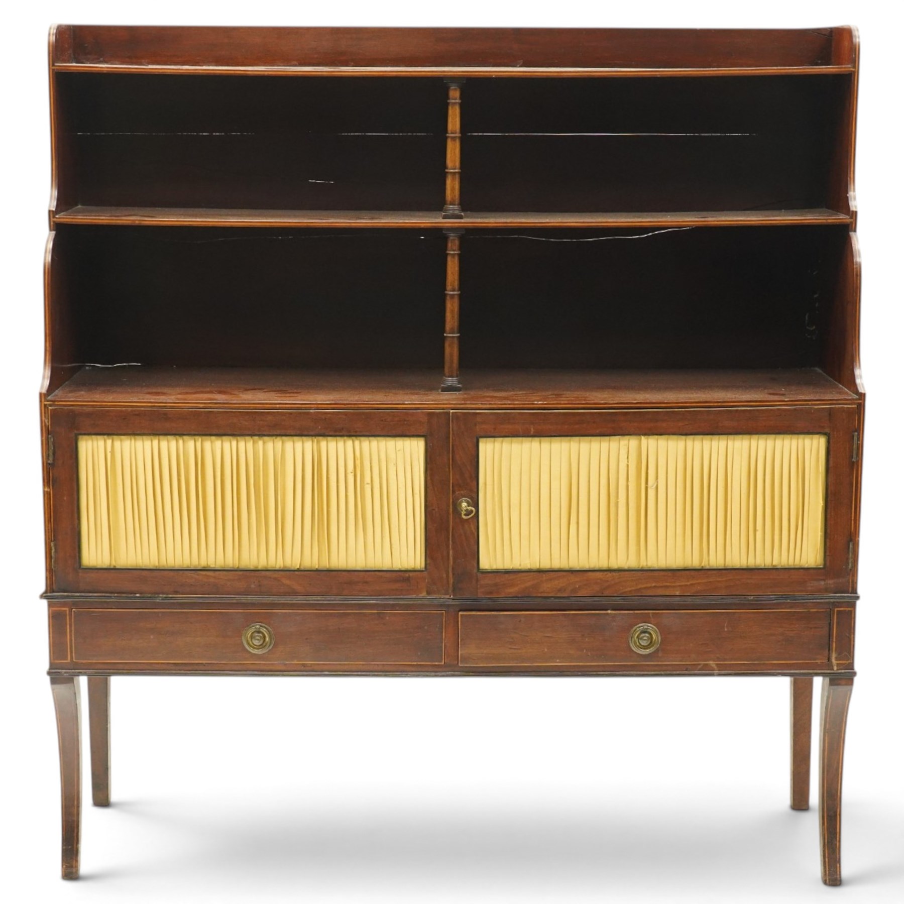 Regency period mahogany waterfall-bookcase chiffonier, the raised back with two open shelves supported by central ring-turned pilasters, fitted with twin doors with sage-green pleated fabric facias, over two drawers with satinwood stringing, raised on front sabre supports