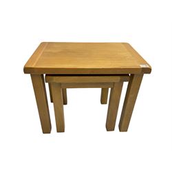 Light oak nest of two tables, rectangular top raised on square supports