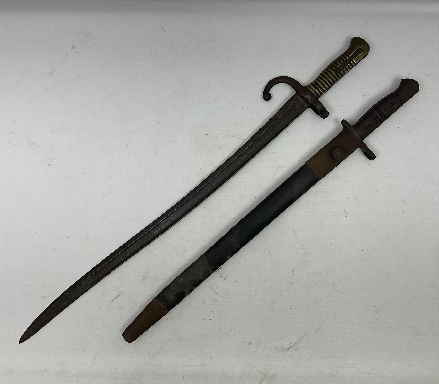 WWI Remington Pattern 1913 bayonet, the 43cm fullered blade with various marks to the ricasso including date code 11 16; in leather covered scabbard with various stamps including JWB 17 L58cm overall; and a French Model 1866 sabre bayonet (no scabbard)