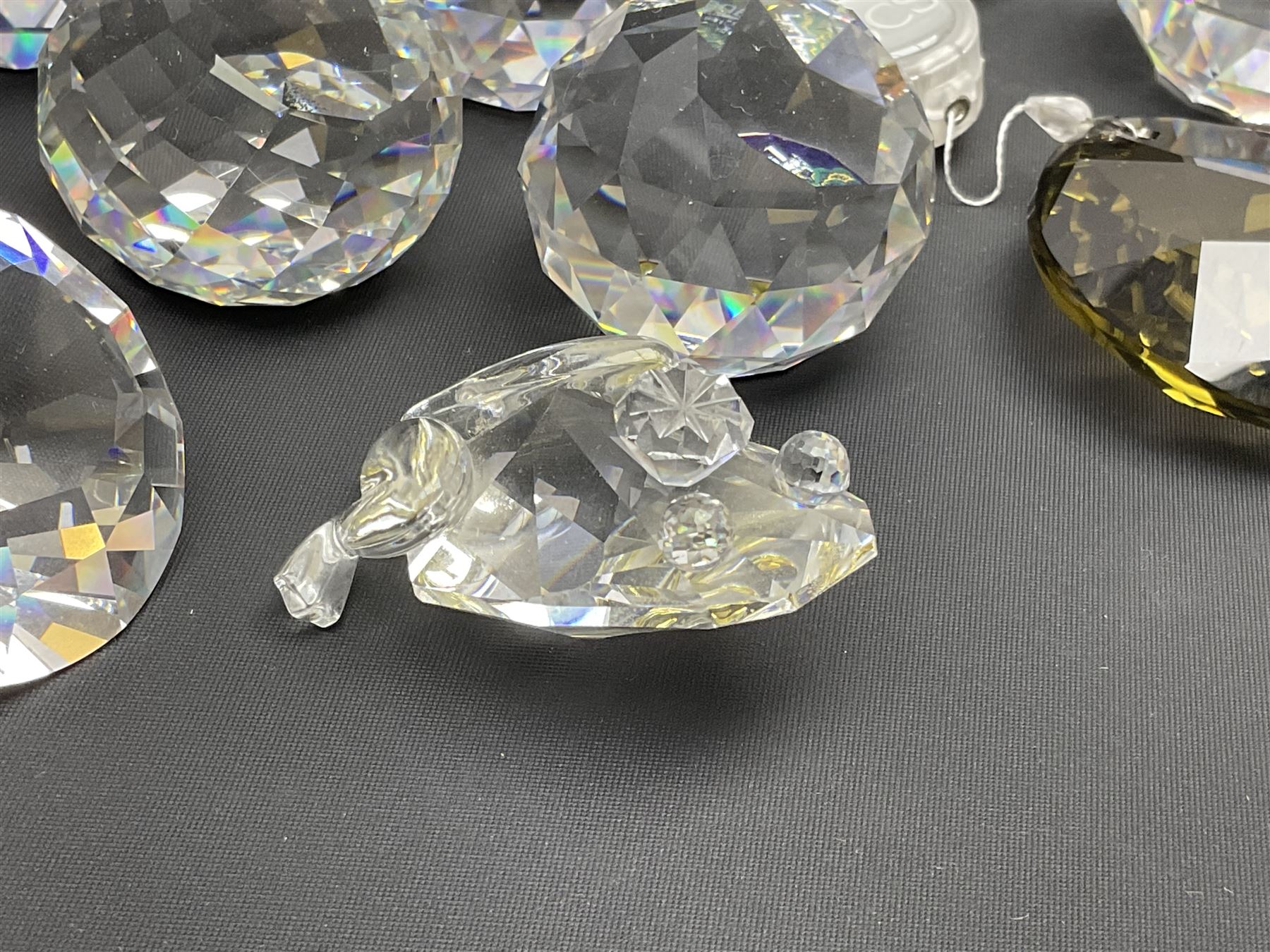 Swarovski Crystal paperweights, to include a globe with dove to the top, pyramid shapes etc, together with a large collection of boxes and stands  