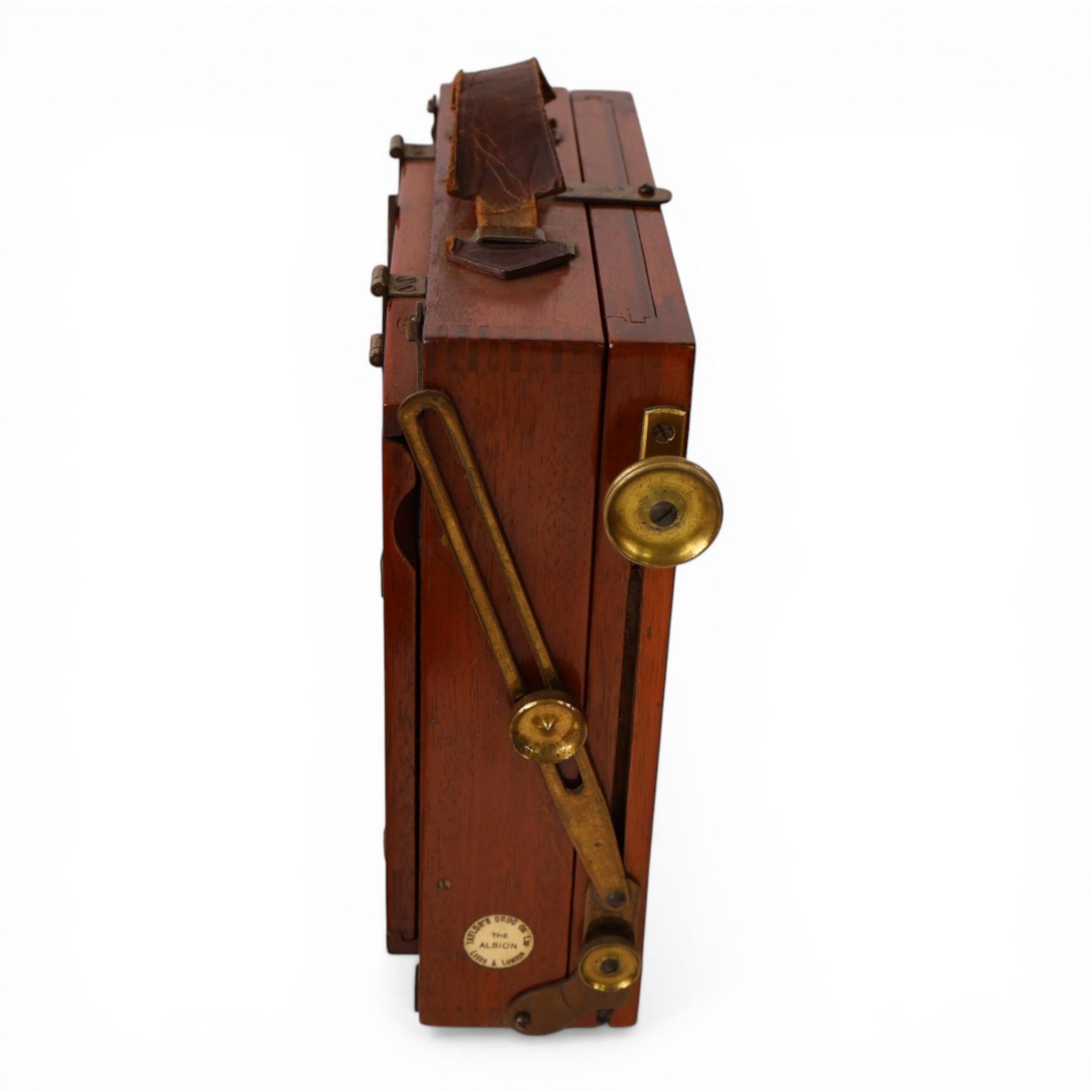 IVORY Early 20th century Taylor's Drug Co. The Albion half plate camera, with brass lens two plates numbered 2 and 4,and accessories, in leather carry case