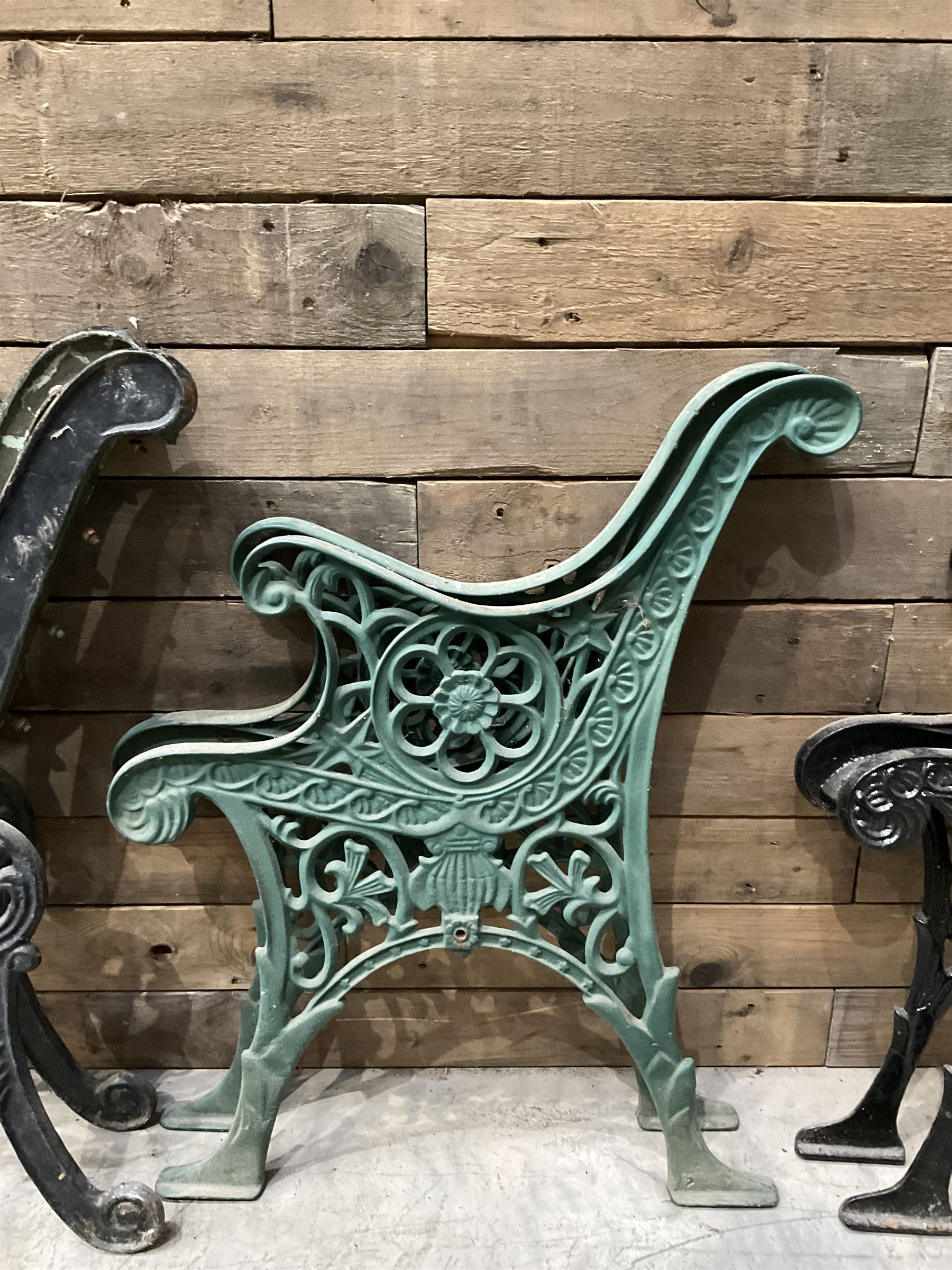 Four pairs of ornate cast iron bench ends (8)