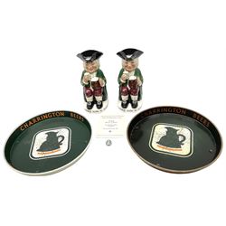 Pair of Royal Doulton Toby Ale Jugs, produced in 1934 for Charrington Ales, together with two circular metal serving trays advertising Charrington brewery, a Charrington badge awarded for 25 years of service and a 1949 menu Fox & Nicholl Ltd annual dinner dance at the toby jug hotel.  