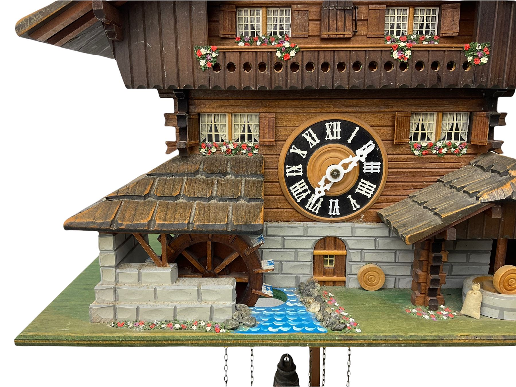 An automaton musical cuckoo clock with a 20th century three weight movement in the form of a Swiss Chalet with a working waterwheel, traditional dial and hands, thirty-hour movement with a cuckoo sounding the hours and half hours on twin bellows, hours followed by one of three tunes played on a musical box and the revolving of the water wheel. With pendulum and weights.




