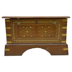 Zanzibar chest, early 20th century, of hardwood construction with brass inlaid foliate and geometric decoration to the lid, fitted interior of multiple carved compartments, with brass strapwork, side handles, and shaped bracket feet